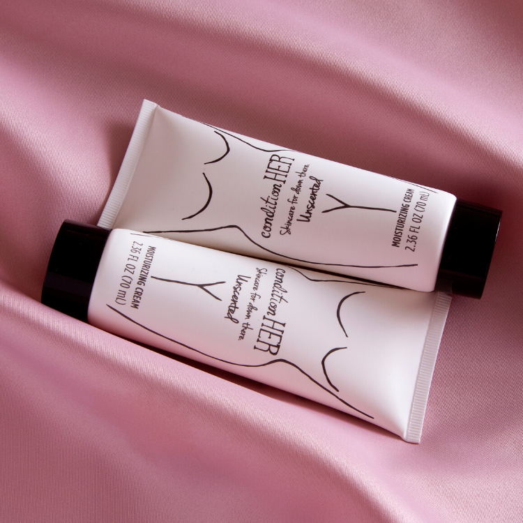 Closeup-of-Two-tubes-of-conditionHERcream-on-lightpink-silk
