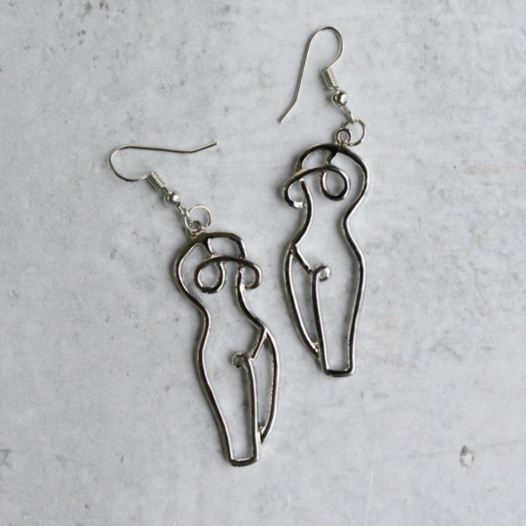 Close-up-of-silver-drop-earrings-featuring-unique-woman-form-line-art-inspired-design