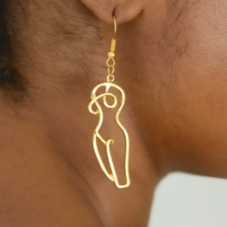 Close-up-of-woman-wearing-gold-drop-earrings-featuring-unique-woman-form-line-art-inspired-design